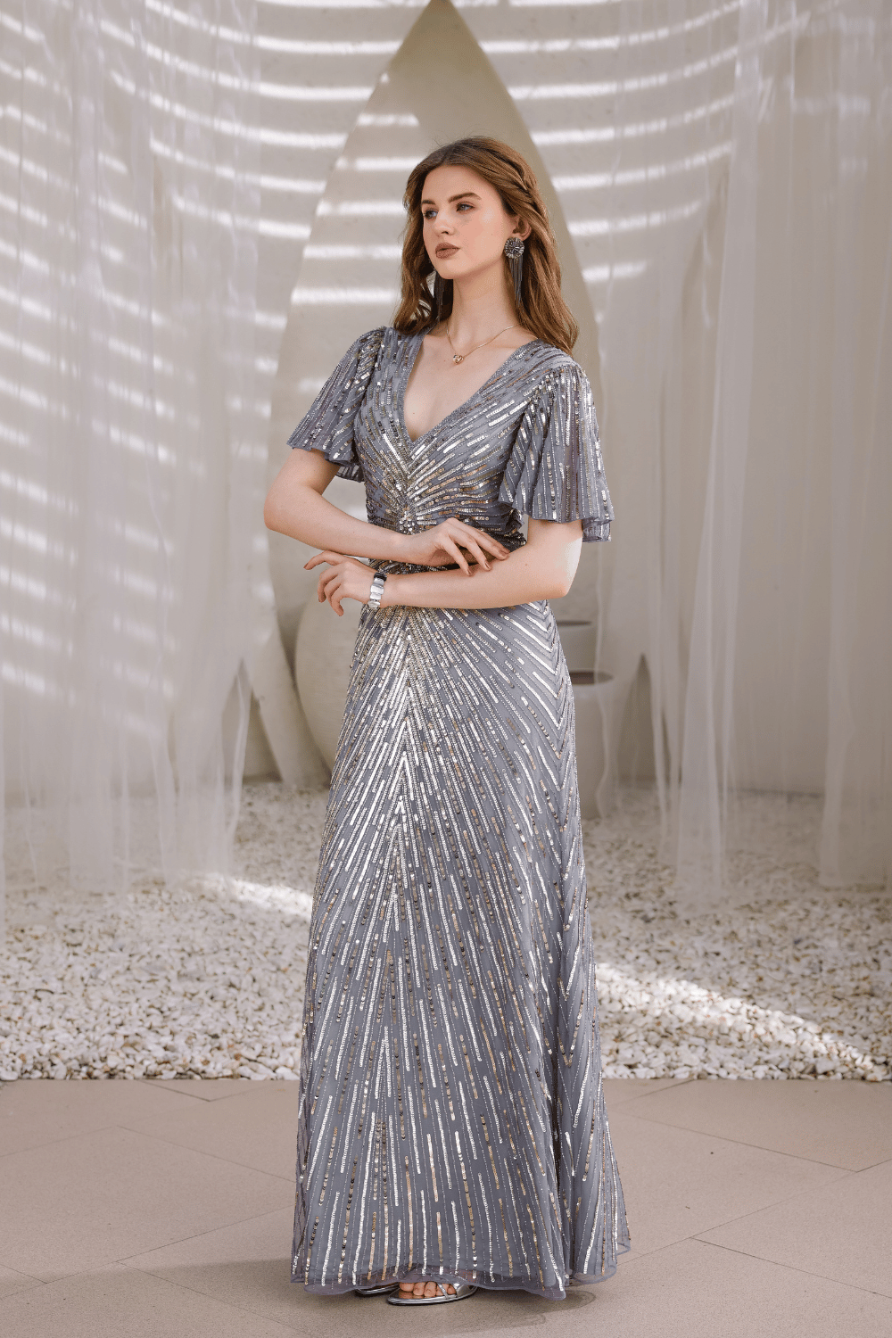 Lifestyle shot: woman wearing Edition Two silver hand-beaded gown at gala event – designer dress India