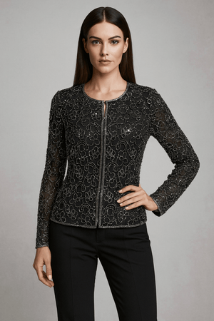 Ivory lace cape styled over black innerwear – sheer layering contrasts with dark base