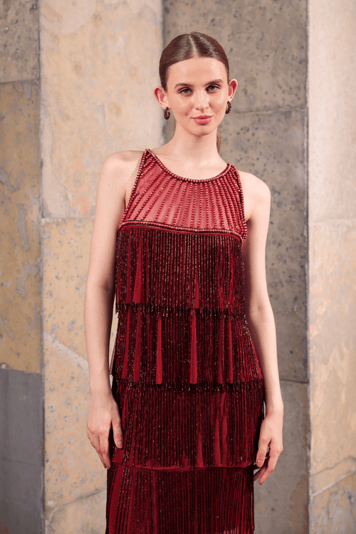 Model wearing wine-colored hand-beaded fringe dress – front view