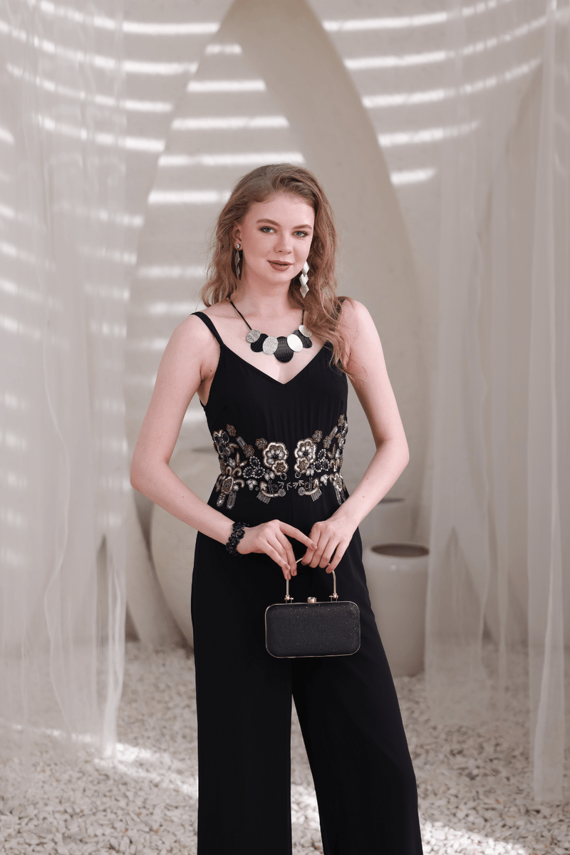 Model wearing black wide-leg embellished jumpsuit – front full view