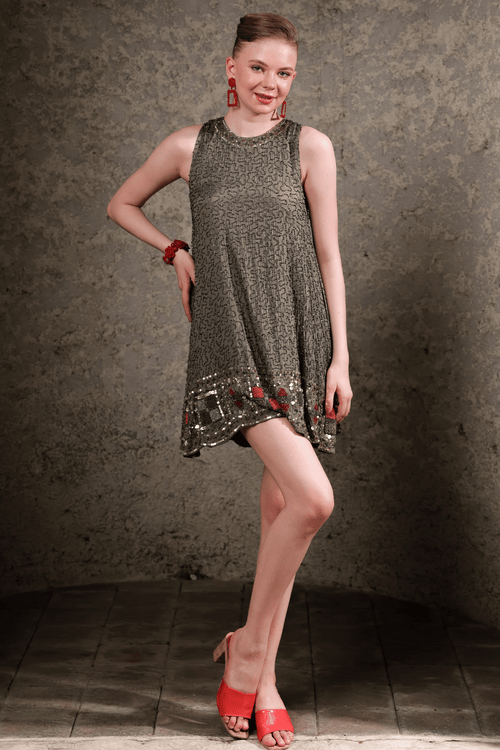 Full body pose of olive shift dress showing fit and sparkle in natural light