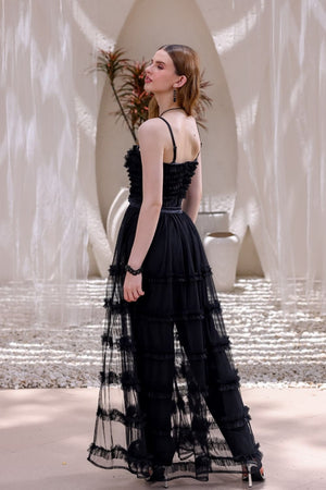 Back view of black tulle jumpsuit with flowing tiered overlay