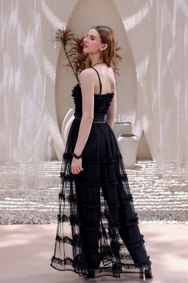 Back view of black tulle jumpsuit with flowing tiered overlay