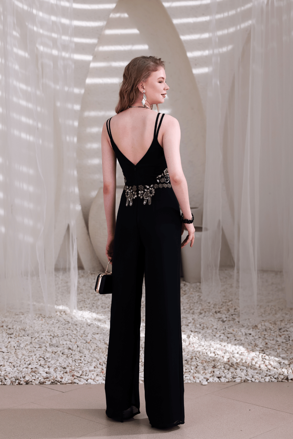 Model wearing black wide-leg embellished jumpsuit – front full view