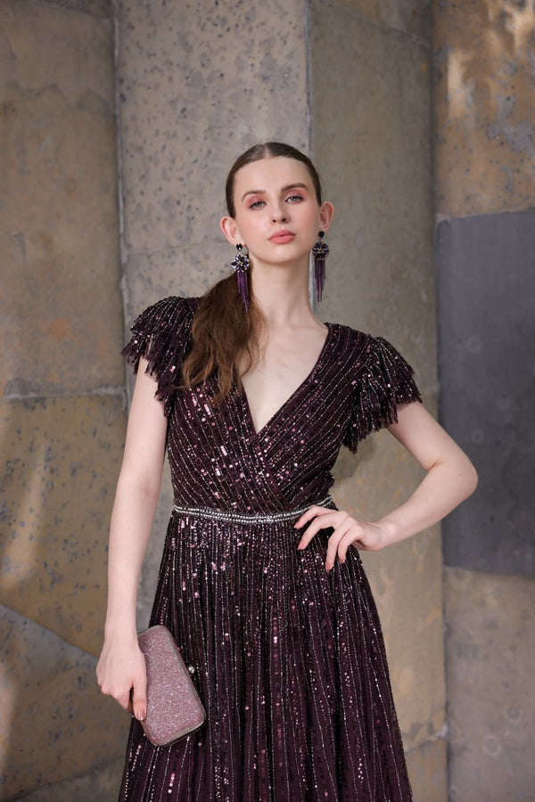 Model posing in blackberry gown – soft lighting and elegant styling