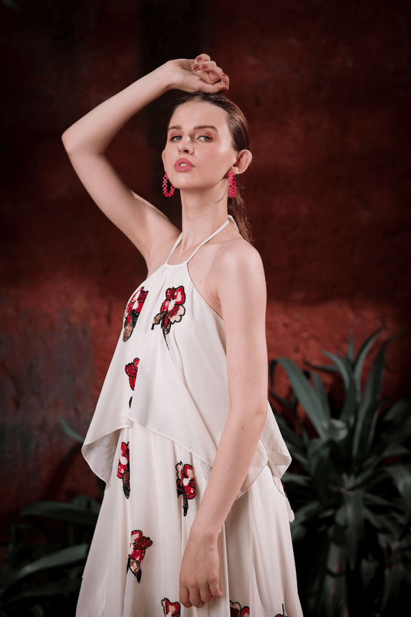 Lifestyle shot: woman wearing Edition Two ivory halter dress with hand-embroidered florals at a gala – modern designer gown India