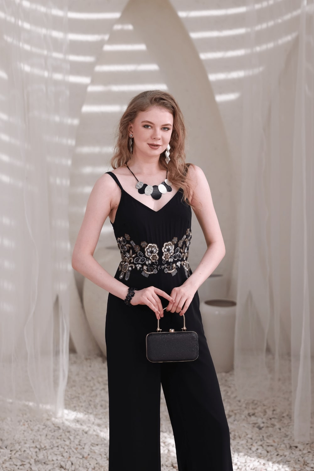 Model wearing black wide-leg embellished jumpsuit – front full view