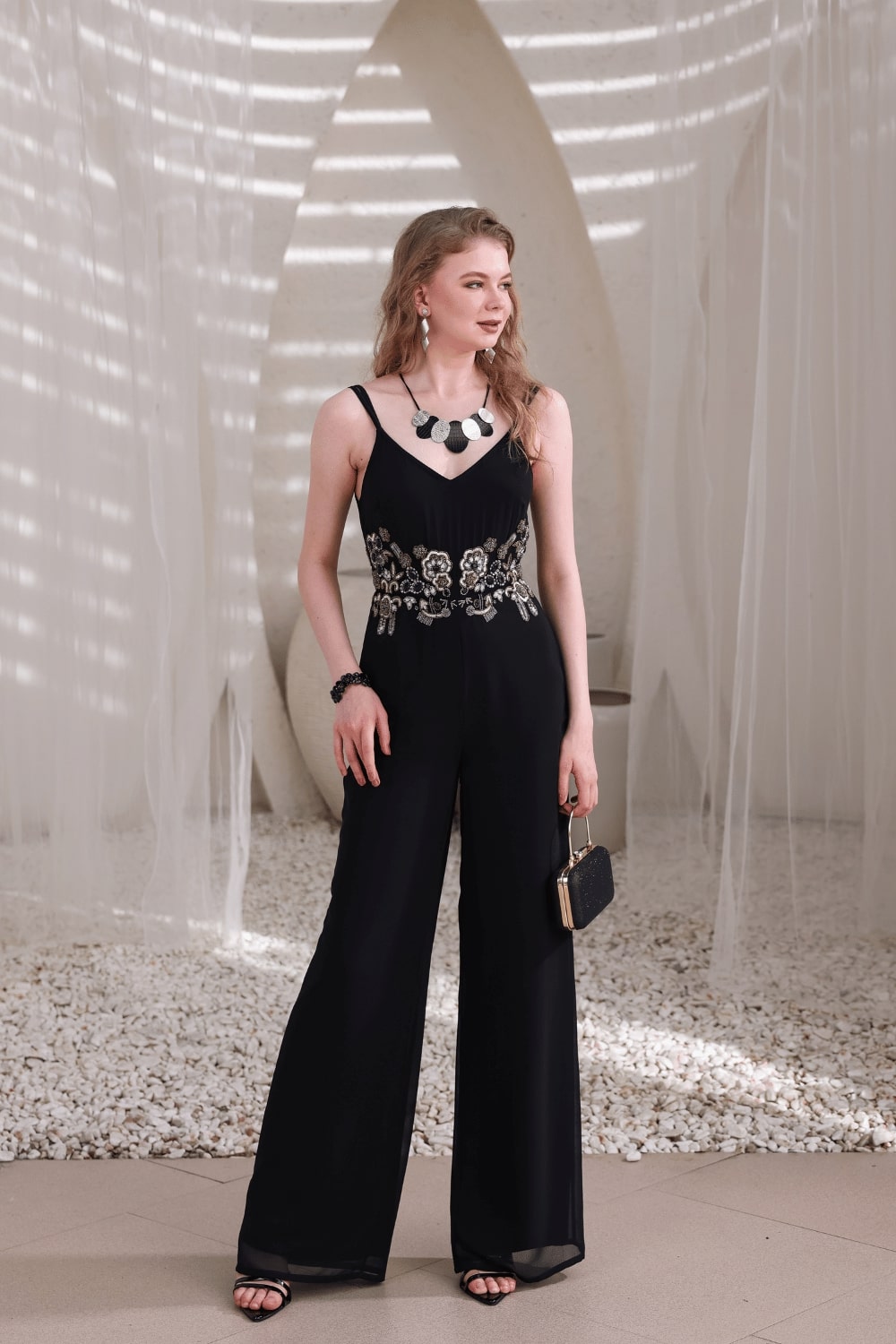 Full-body pose showing flowy wide-leg cut and handcrafted embellishments