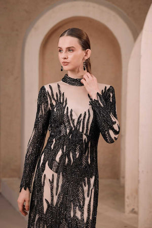 Studio shot of black flame illusion dress on model – full-length frontal display