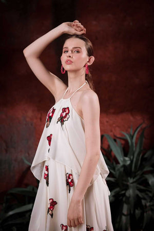 Lifestyle shot: woman wearing Edition Two ivory halter dress with hand-embroidered florals at a gala – modern designer gown India