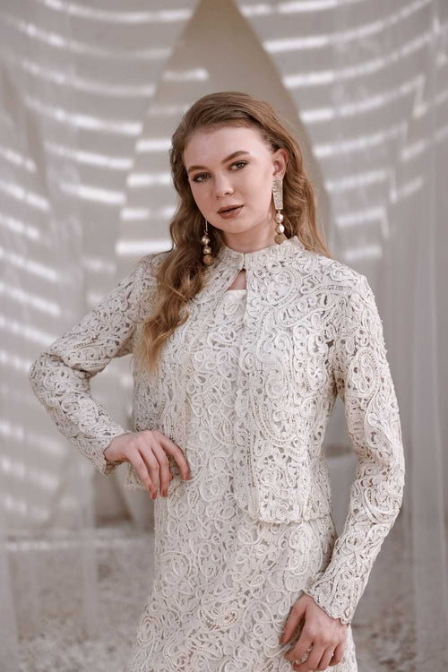 Front close-up of ivory lace shrug showing sheer embroidered texture