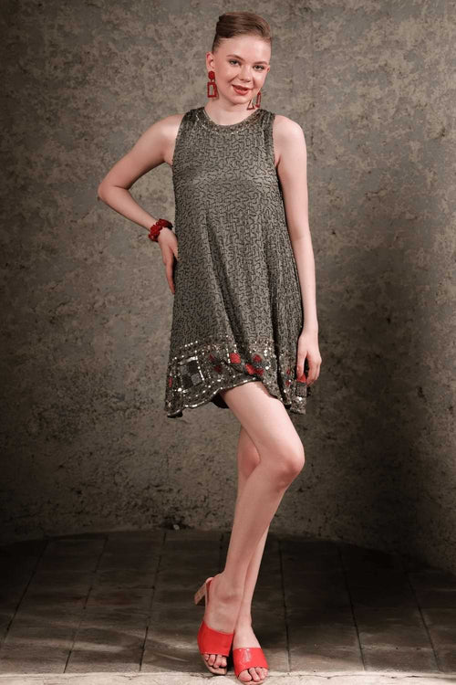 Side view of olive shift dress showing fit and sparkle in natural light