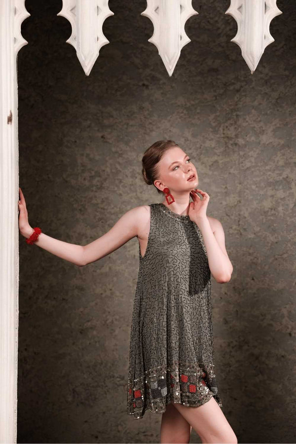 Full body pose of olive shift dress showing fit and sparkle in natural light