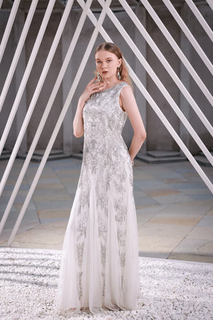 Model walking and twirling in ivory embellished floor-length gown – showing full movement, sequin detailing, and luxury fabric flow