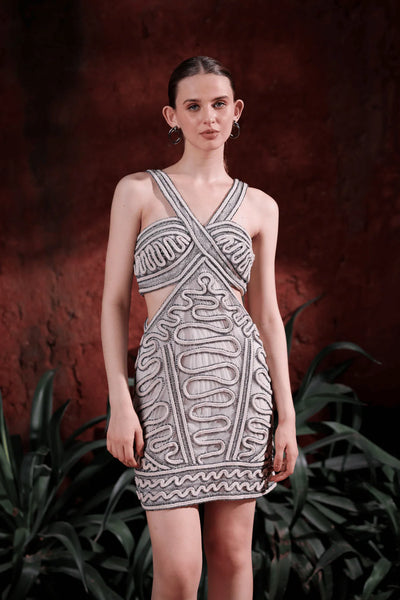 Model showcasing embellished cut-out mini dress in motion — highlighting side cut-outs, shimmer detailing, and modern party style