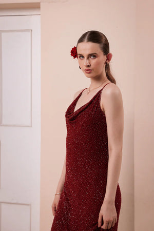 Model walking in wine red hand-embellished slip dress — capturing fluid motion, delicate beading, and graceful silhouette in evening lighting