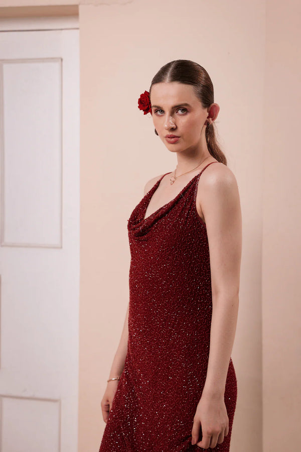 Model walking in wine red hand-embellished slip dress — capturing fluid motion, delicate beading, and graceful silhouette in evening lighting